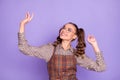 Photo of charming positive young lady dancing look empty space have good mood isolated on violet color background