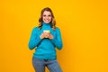 Photo of charming pretty lady hold hot tea beverage cup toothy smiling enjoy weekend leisure wear specs blue sweater Royalty Free Stock Photo