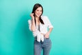 Photo of charming pretty nice young woman hold hand pocket wear casual outfit isolated on teal color background