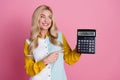 Photo of charming pretty woman banker showing nubmers money income isolated on pink color background