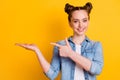 Photo of charming pretty young teen lady two buns direct finger open arm show novelty shopping product low price amazing