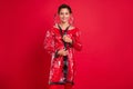 Photo of charming shiny young woman dressed rubber coat hood smiling isolated red color background Royalty Free Stock Photo