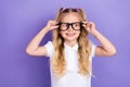 Photo of charming small girl tails arms touch eyewear oculist checkup dressed stylish white blouse on violet