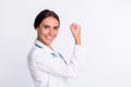 Photo of charming strong young lady physician dressed uniform rising fists smiling isolated white color background