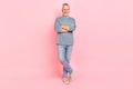 Photo of charming sweet man pensioner dressed grey shirt smiling arms crossed isolated pink color background Royalty Free Stock Photo