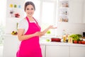 Photo of charming sweet mature woman dressed pink apron inviting you her kitchen indoors house home room Royalty Free Stock Photo