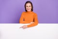 Photo of charming sweet retired woman wear orange pullover spectacles pointing blank board empty space isolated violet Royalty Free Stock Photo