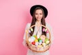 Photo of charming sweet young lady wear white outfit cap holding easter bucket isolated pink color background