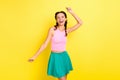 Photo of charming sweet young woman pigtails wear tank top dancing smiling isolated yellow color background Royalty Free Stock Photo