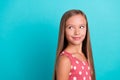 Photo of charming thoughtful small girl wear pink dress smiling looking empty space isolated turquoise color background