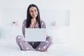 Photo of charming thoughtful young woman nightwear sitting bed writing modern gadget arm chin inside indoors home room