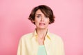 Photo of charming upset unsure guilty young woman wear yellow shirt isolated pink color background