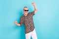 Photo of charming victorious old man raise fists winner wear cool sunglass isolated on blue color background