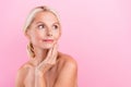 Photo of charming woman touching fresh skin advertising cleansing exfoliant lotion looking empty space on pink