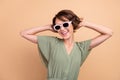 Photo of charming young joyful woman free time dance wear sunglass cool isolated on beige color background Royalty Free Stock Photo