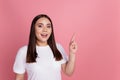 Photo of cheerful adviser lady direct forefinger empty blank space wear white t-shirt isolated on pink background Royalty Free Stock Photo