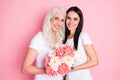 Photo of cheerful aged mother young daughter ladies holding fresh flowers bunch blossom celebrating 8 march together