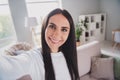 Photo cheerful attractive young woman take selfie camera in living room wear white sweater indoors in house