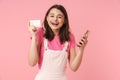 Photo of cheerful charming girl holding cellphone and credit card