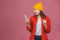 Photo of cheerful cute beautiful young woman chatting by mobile phone isolated over pink wall background