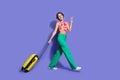 Photo of cheerful cute good mood girl wear trendy clothes go airport fly abroad sea resort vacation isolated on purple Royalty Free Stock Photo