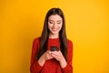 Photo of cheerful cute gorgeous attractive youngster holding telephone with hands smiling toothily browsing through