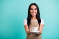 Photo of cheerful cute pretty charming woman server giving you cup of delicious coffee smiling toothily isolated teal
