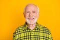 Photo of cheerful elderly man pensioner grandfather happy positive toothy smile isolated over yellow color background