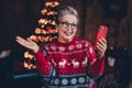 Photo of cheerful excited woman wear red print xmas sweater glasses getting modern gadget video christmas greetings Royalty Free Stock Photo