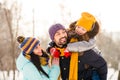 Photo of cheerful family mommy daddy daughter piggyback happy positive smile look each other winter trip outdoors