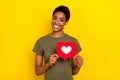 Photo of cheerful friendly person hold paper like card beaming smile isolated on yellow color background Royalty Free Stock Photo