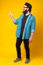 Photo of cheerful full length bearded man pointning away Royalty Free Stock Photo