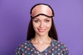 Photo of cheerful girl look in camera with eye patches she apply before soft healthy sleep wear dotted pajama isolated