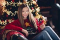 Photo of cheerful girl teenager using cellphone searching gifts to prepare for 2024 happy new year purchase surprises Royalty Free Stock Photo