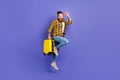 Photo of cheerful glad guy wear trendy clothes hand hold suitbag hurry airport relax rest resort abroad isolated purple Royalty Free Stock Photo
