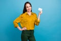 Photo of cheerful good mood girl dressed yellow shirt rising credit card isolated blue color background