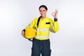 Photo of cheerful good mood young firewoman dressed yellow uniform helmet showing okey isolated white color background