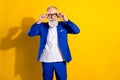 Photo of cheerful grey beard elder man wear spectacles blue jacket isolated on vivid yellow color background