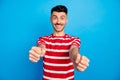 Photo of cheerful handsome young man steering wheel hands driver wear red striped t-shirt isolated on blue color