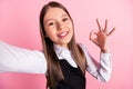 Photo of cheerful happy positive brunette small girl make camera selfie show okay sign isolated on pink color background