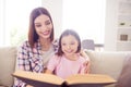 Photo of cheerful happy positive siblings sisters read book smile good mood bond indoors inside house home