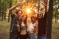 Photo of cheerful hippie people men and women, smiling while walking in forest Royalty Free Stock Photo