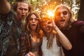 Photo of cheerful hippies men and women, smiling and taking self