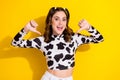 Photo of cheerful impressed girl with curly hairdo dressed cow long sleeve indicating at herself isolated on yellow Royalty Free Stock Photo