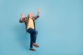 Photo of cheerful impressed retired man wear plaid shirt rising arms up empty space isolated blue color background