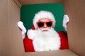 Photo of cheerful impressed santa dressed red costume open new year present box isolated green color background Royalty Free Stock Photo
