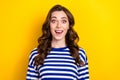 Photo of cheerful impressed young lady wear striped shirt smiling open mouth isolated yellow color background
