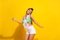 Photo of cheerful joyful dark skin young woman dance happy funky lady isolated on shine yellow color background