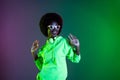 Photo of cheerful lady dance enjoy wear headphones glasses sweatshirt isolated gradient green neon background Royalty Free Stock Photo