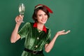 Photo of cheerful lady drink champagne congratulations event wear elf costume hat isolated green color background Royalty Free Stock Photo